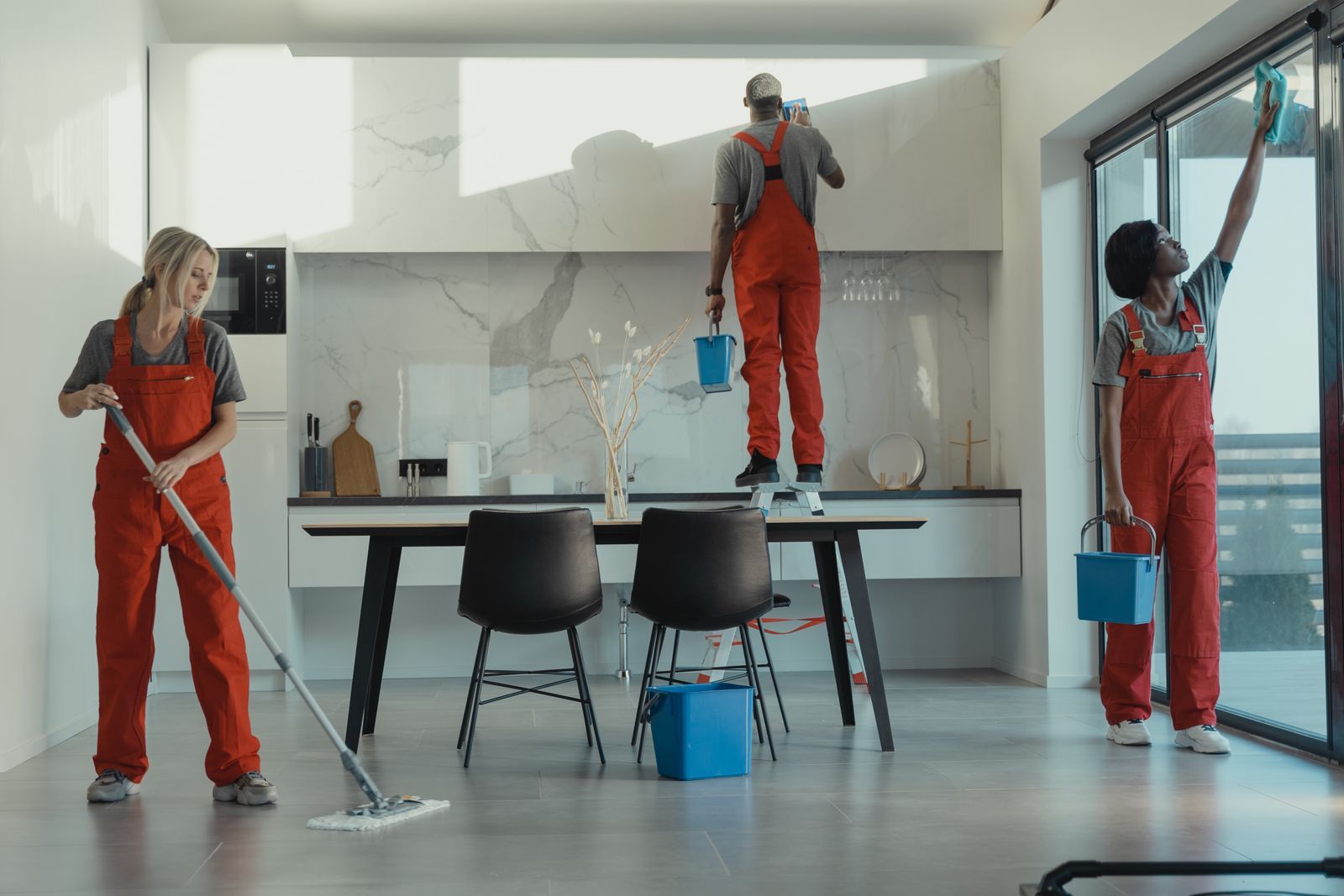 Cleaning crew finishing a deep clean in a newly completed space