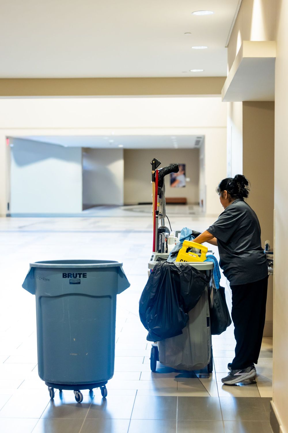 Office hallway cleaning with a fully stocked janitorial cart