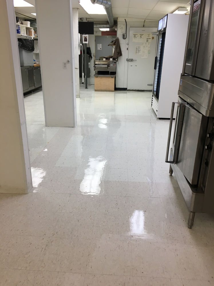 A commercial kitchen floor stripped and waxed to a shine by Prairie Building Maintenance